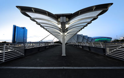 Bridge against clear blue sky in city