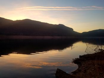 Scenic view of lake against sky during sunset