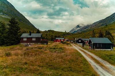 Houses on field against sky