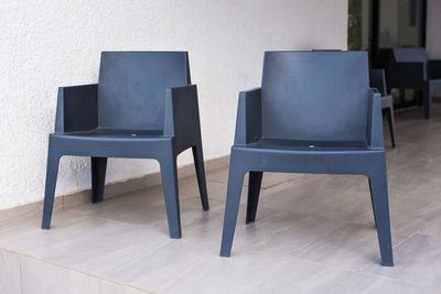 Empty chairs and table against wall at home