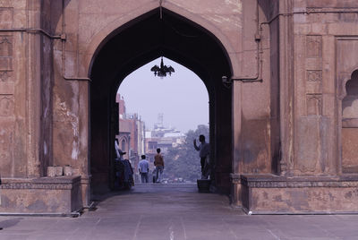 People walking in front of historical building
