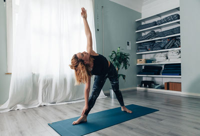 Yogic woman practicing in yoga studio