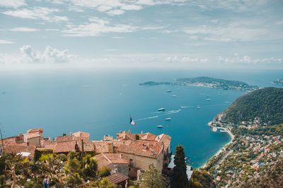 High angle view of buildings and sea against sky