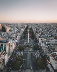 High angle view of city street and buildings against sky