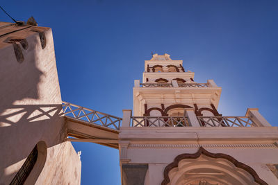 Low angle view of clock tower against clear blue sky