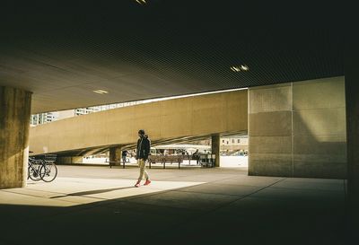 Man walking under parking lot