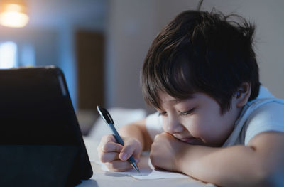 Boy using digital tablet at home