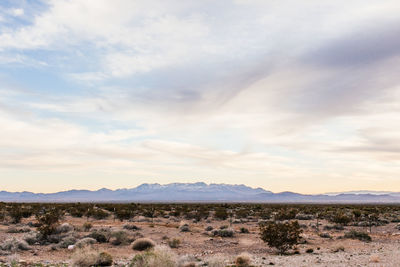 Scenic view of mountains against cloudy sky