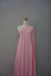 Close-up of clothes hanging on wall against black background