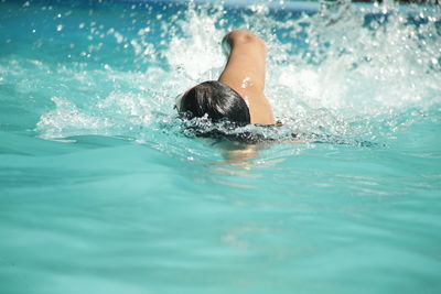 Man swimming in pool