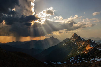 Aerial view of snowcapped mountains against sky during sunset