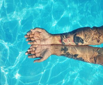 Low section of woman swimming in pool