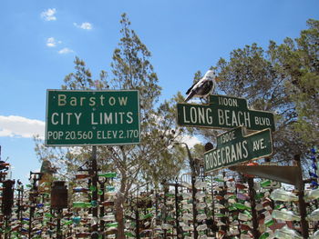 Low angle view of road sign against sky