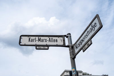 Low angle view of road sign against sky