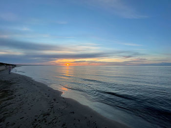 Scenic view of beach against sky during sunset