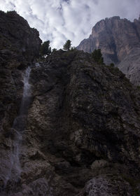 Low angle view of rocky mountains against sky