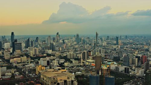 High angle view of modern buildings in city against sky during sunset