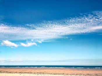 Scenic view of sea against blue sky