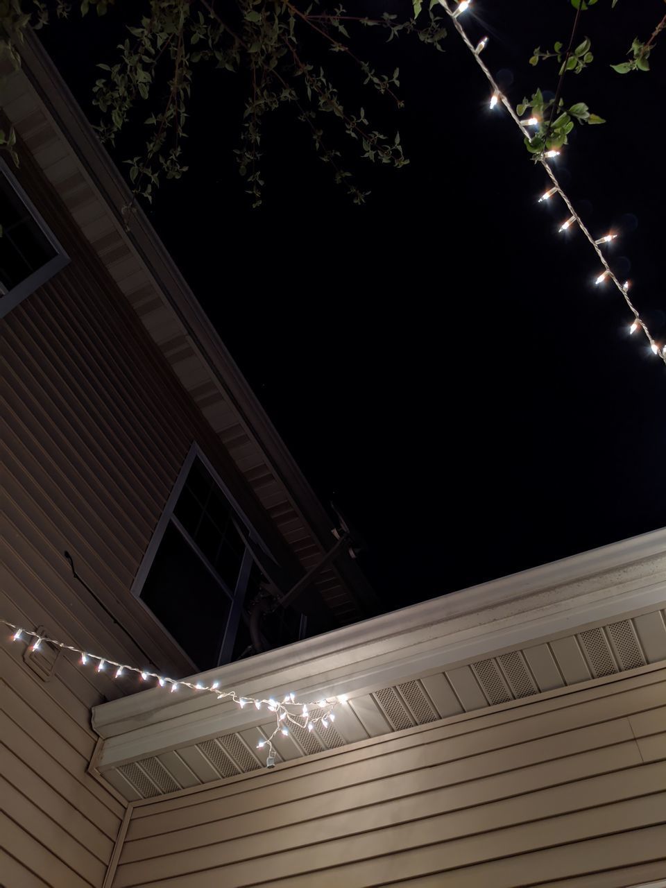 LOW ANGLE VIEW OF ILLUMINATED BUILDINGS AGAINST SKY