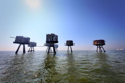 Lifeguard hut on beach against clear blue sky