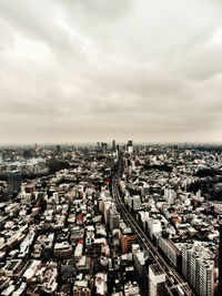Cityscape against cloudy sky