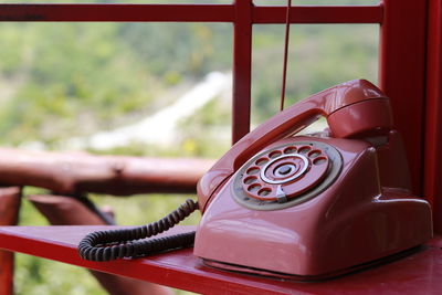 Close-up of telephone booth on table