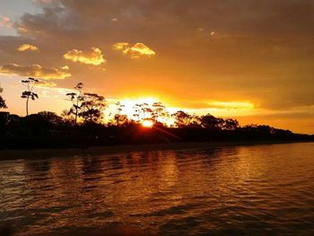 Scenic view of lake at sunset