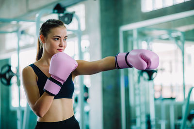 Young woman boxing in gym