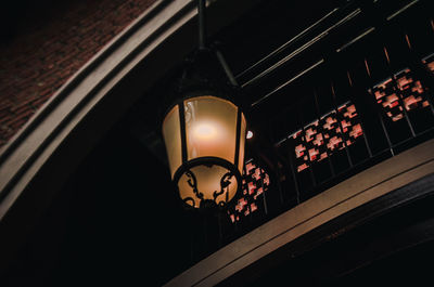 Low angle view of illuminated lighting equipment on window