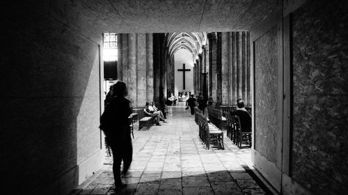 Full length of young woman standing on tiled floor