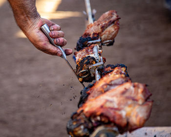 Cropped hand of person preparing food