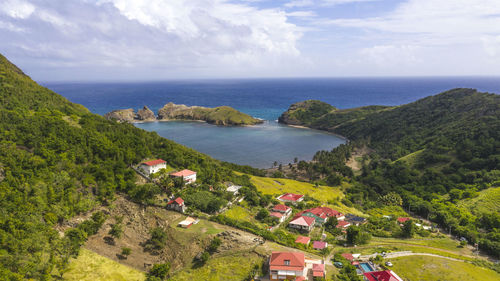 High angle view of townscape by sea against sky