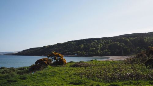 Scenic view of sea and mountains against sky