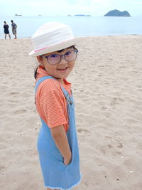 A little cutest girl wearing white hat smile at the samila beach, amphoe mueang songkhla thailand