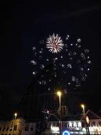 Low angle view of firework display at night