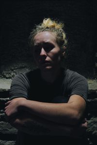 Depressed woman sitting in basement