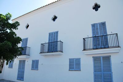 Low angle view of buildings against clear blue sky