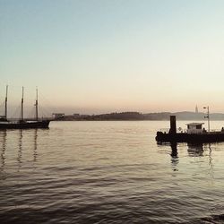 Boats in sea at dusk