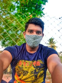 Portrait of young man standing outdoors ,wear mask stay safe