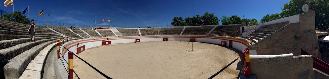 Panoramic view of amphitheater against blue sky