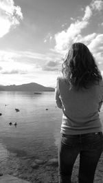 Rear view of woman standing against sky