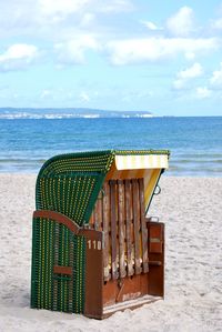 Lifeguard hut on beach against sky