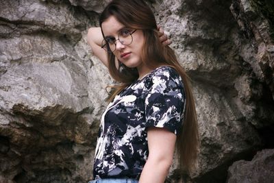 Young woman looking at rock formation