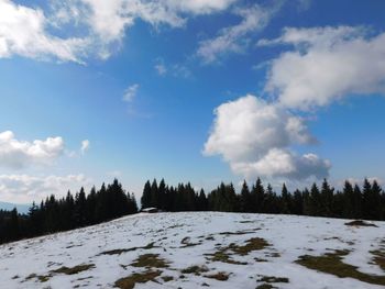 Scenic view of snow covered landscape against sky