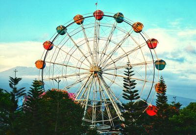 Low angle view of ferris wheel against sky