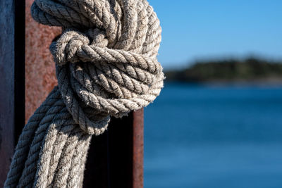 Close-up of rope tied to wooden post