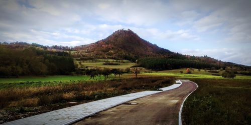 Road amidst landscape against sky