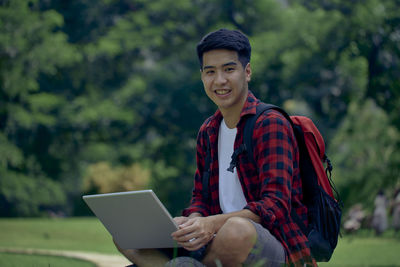 Portrait of young man using mobile phone