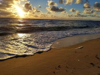 Scenic view of beach against sky during sunset