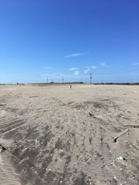 Scenic view of desert against clear blue sky